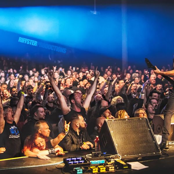 Riffster musical performance Gallery - male guitar player on stage big crowd